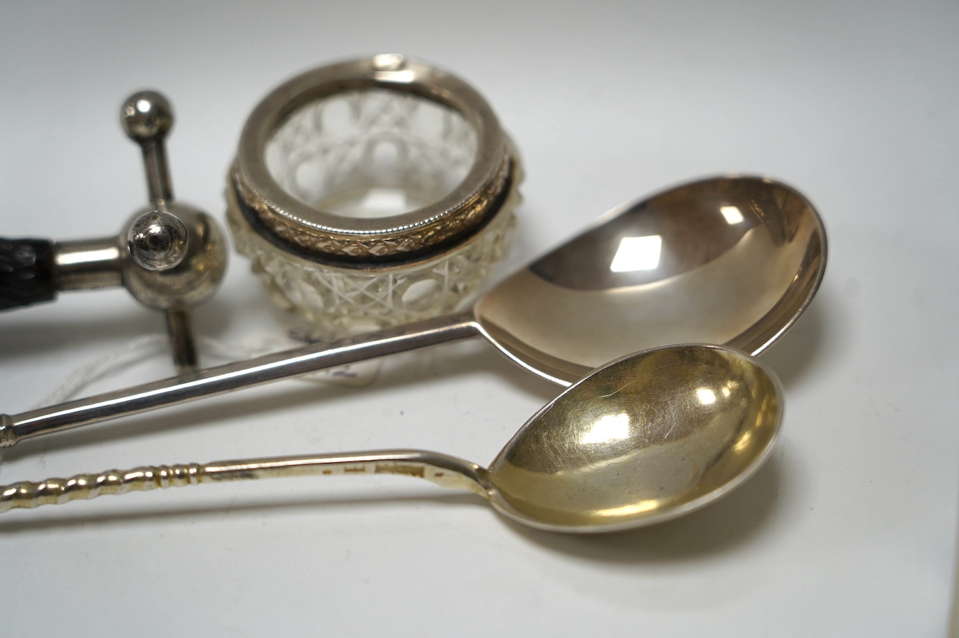 A late 19th century Russian engraved 84 zolotnik spoon, dated 1890, 16.8cm, a George V silver apostle spoon, together with three other items including silver mounted glass salts. Condition - poor to fair to good